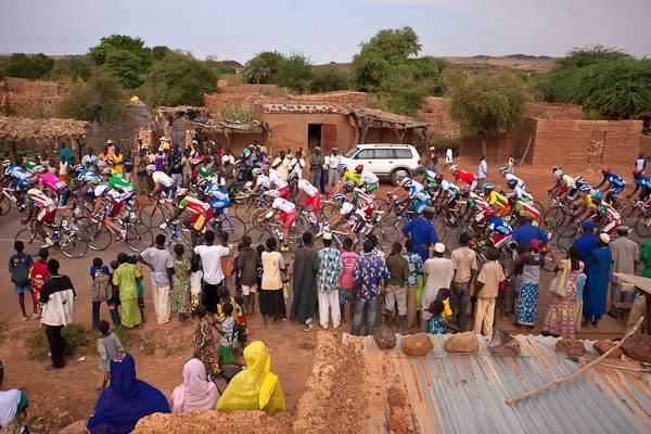 The race comes through a village in a flash of color
