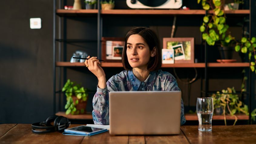 businesswoman using laptop and looking away