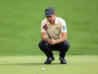 PGA Tour winner Nick Taylor lining up a putt on the green