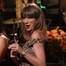 Taylor Swift appears on SNL wearing a plaid mini dress from Simkhai