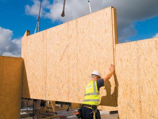 Structural insulated panels being installed on a site by a builder