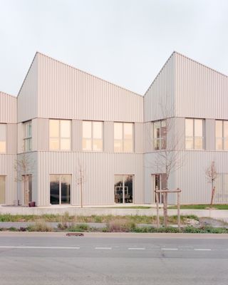 Massy office block with minimalist pitched roofs