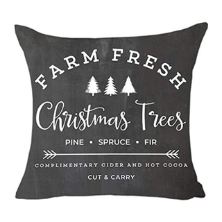 A black throw cushion with printed Christmas themed text