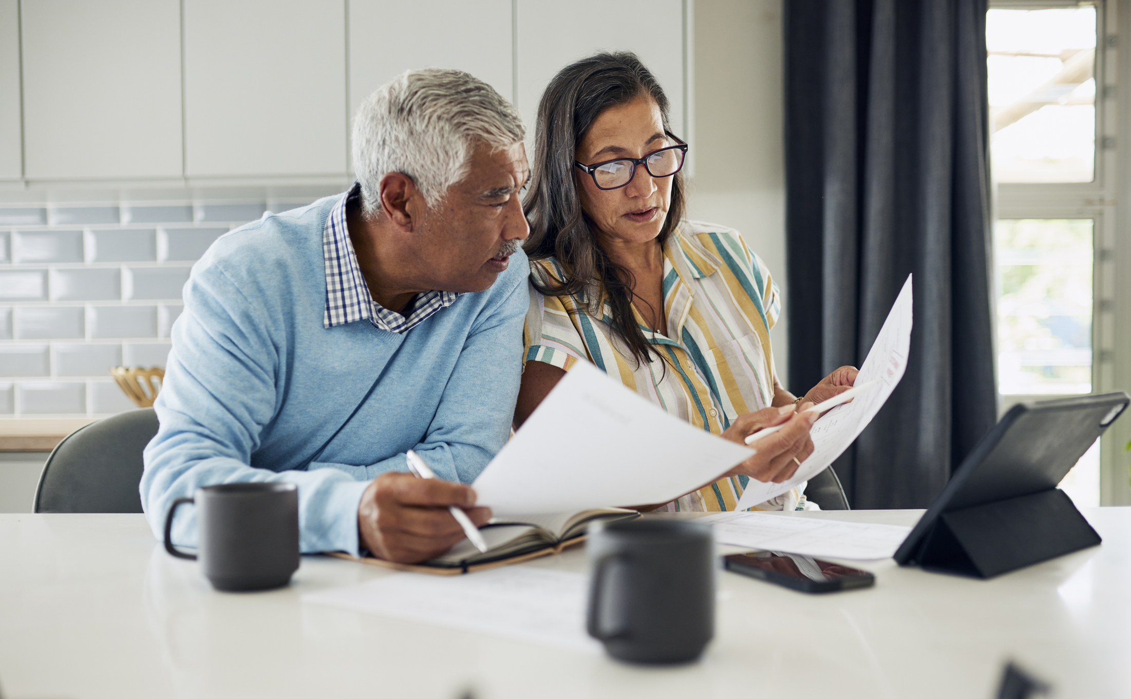 Older couple looking over financial documents