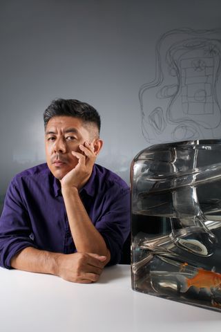 Portrait of architect Ma Yansong shot next to an architecture model