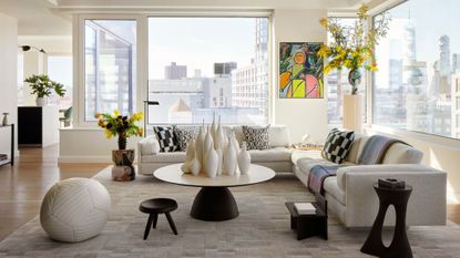 minimalist living room with colorful artwork and NYC skyline views