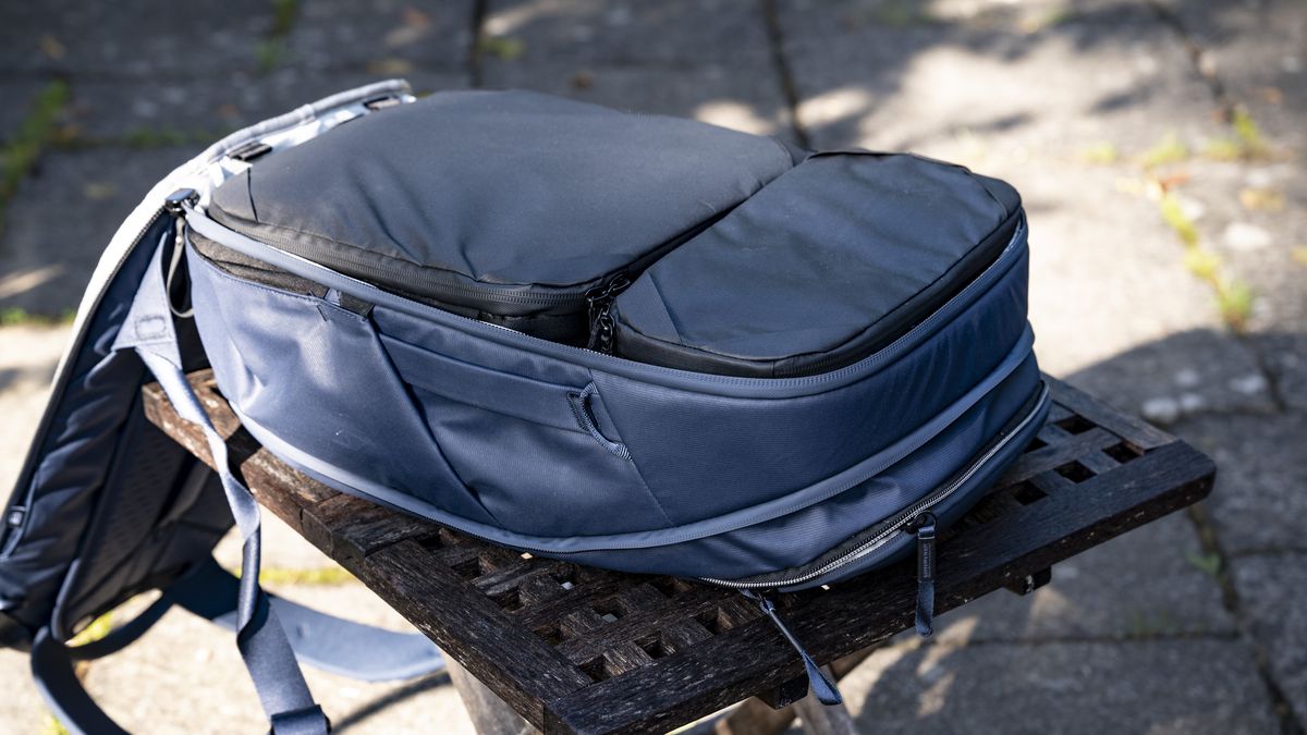 Peak Design Camera Cubes inside the Traveller Backpack on wooden table outside