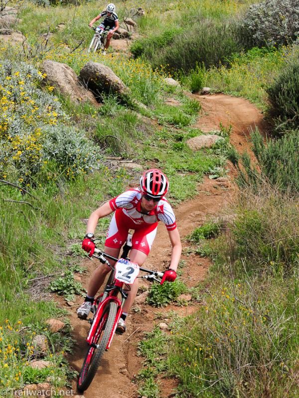 Lea Davison (Specialized) descends singletrack with Emily Batty close behind
