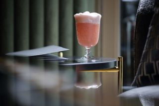 An elegant pink cocktail at The Atheneum Hotel bar