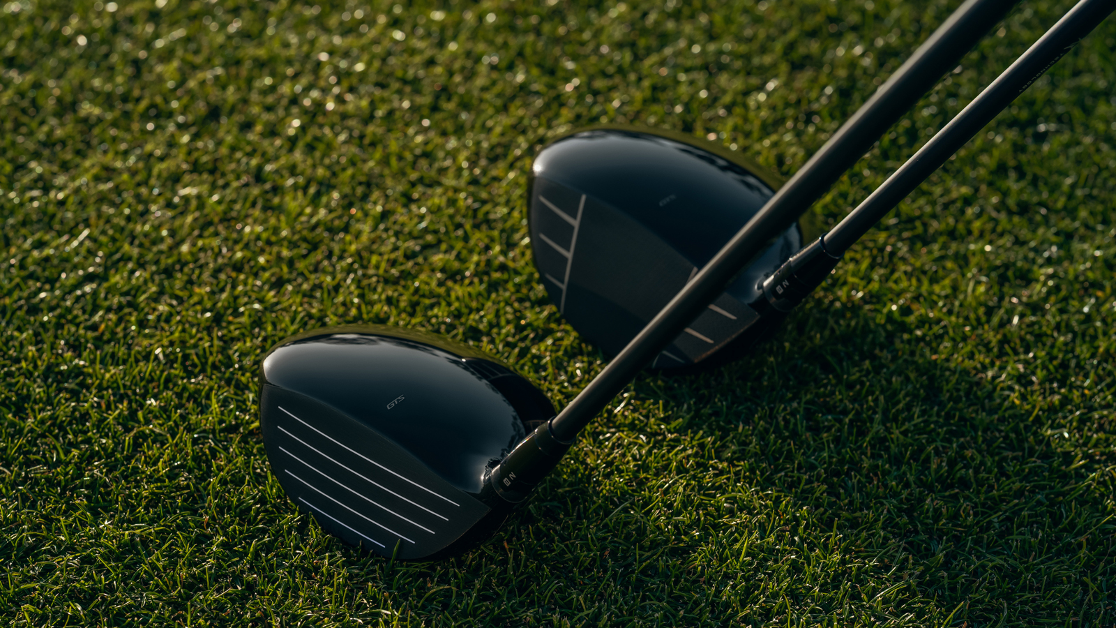 A Titleist mini driver and driver next to each other