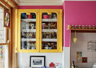 Pink kitchen with yellow cabinetry