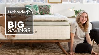 A person sitting next to a bed with the Avocado Alpaca Wool mattress topper on it, with a graphic overlaid saying "BIG SAVINGS"