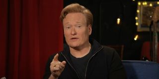 conan o'brien pointing at screen in tbs talk show