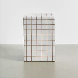 A cubed tiled side table