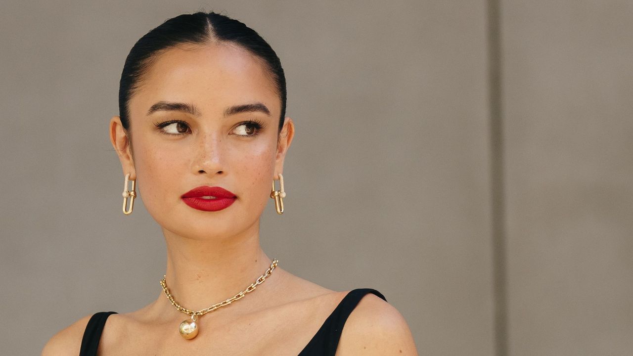 Kelsey Merritt in a low bun, with red lip, smokey eye and gold jewellery at the Spring 2024 New York Fashion Week Runway shows - best mascara