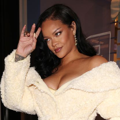 Rihanna pairs a maternity sweatsuit with Puma Speedcat sneakers in lavender