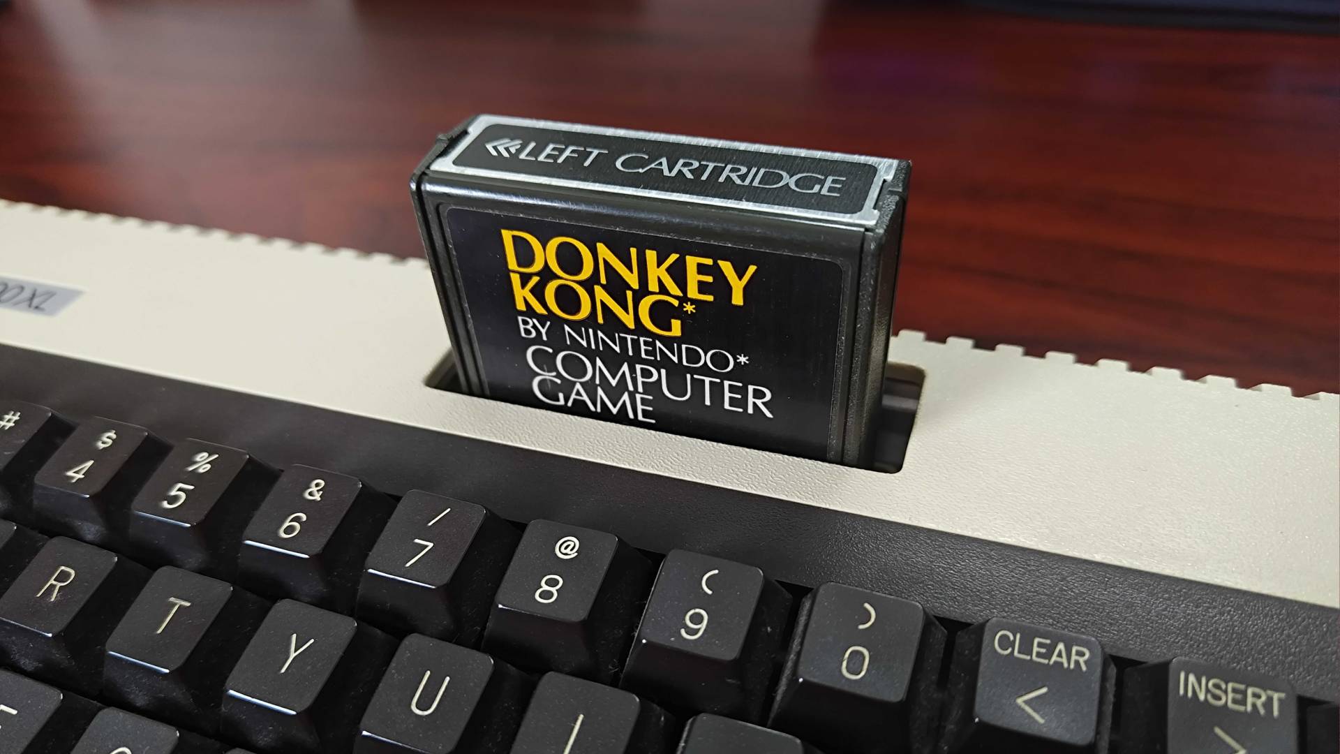 Close up of Atari 600XL with Donkey Kong by Nintendo cartridge in top slot.