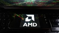 AMD logo on mobile phone sitting on laptop keyboar