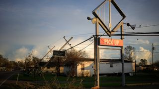 A Domino's Pizza sign damaged by Hurricane Ida in Raceland, Louisiana, on Monday, Aug. 30, 2021.