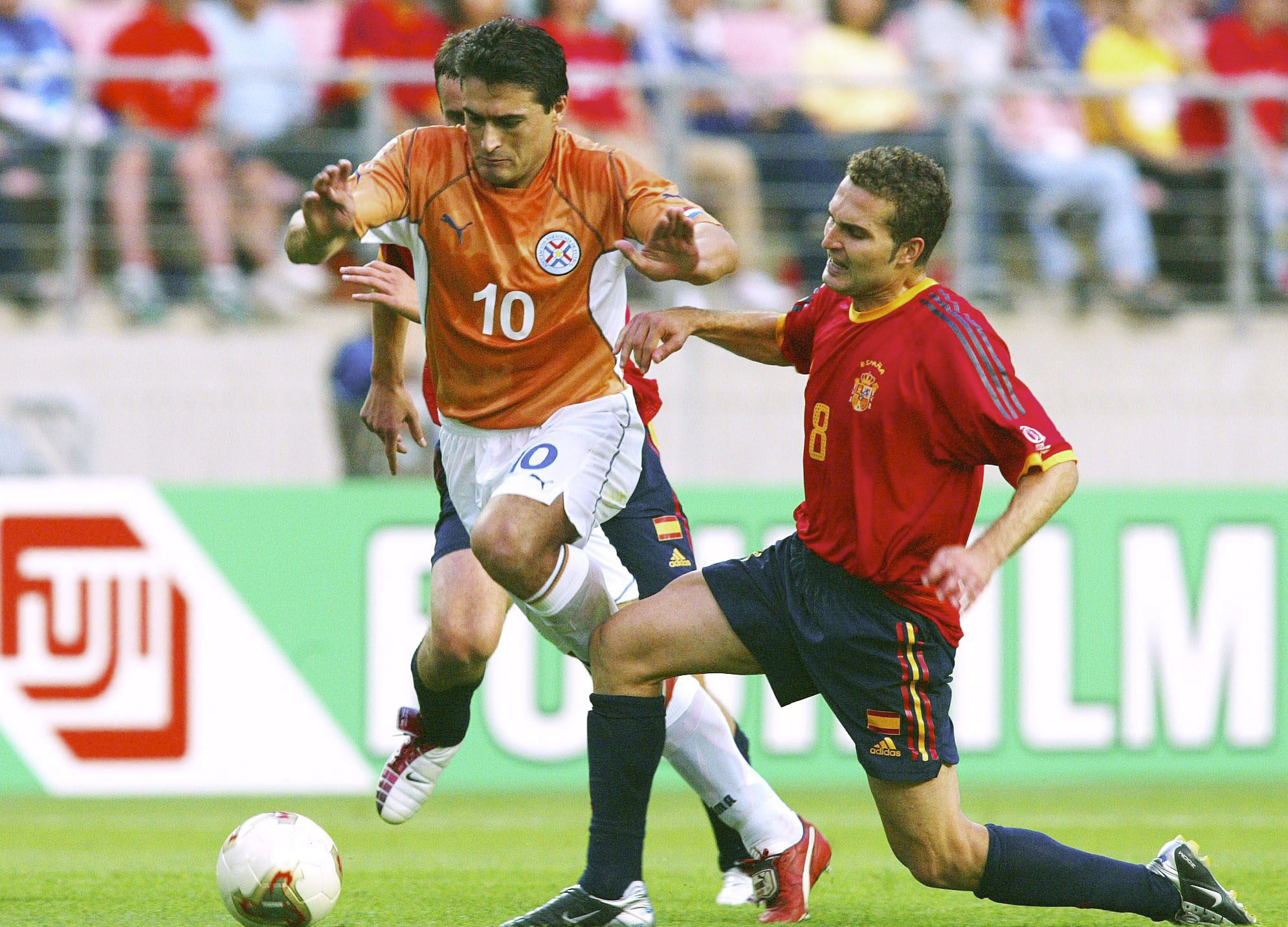 Spain's Ruben Baraja competes for the ball with Paraguay's Roberto Acuña at the 2002 World Cup.