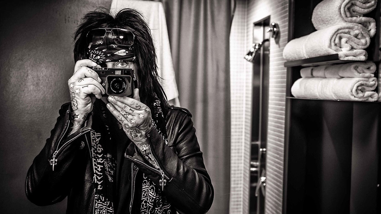 a portrait of nikki sixx with a camera in front of his face