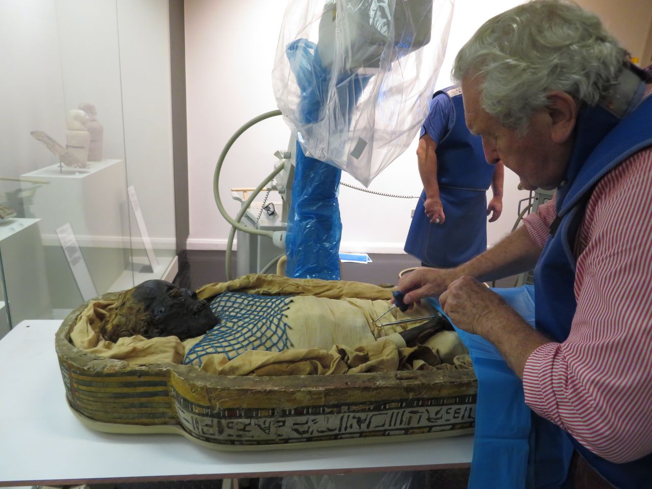 Dr. Robert Loynes, a retired orthopedic surgeon and an honorary lecturer in The University of Manchester's KNH Centre for Biomedical Egyptology, prepares the mummy for study.