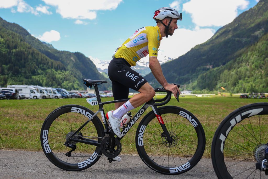 CARI SWITZERLAND JUNE 13 Adam Yates of The United Kingdom and UAE Team Emirates Yellow leader jersey looks on during the 87th Tour de Suisse 2024 Stage 5 a 1486km stage from Ambri to Cari on June 13 2024 in Cari Switzerland Photo by Sara CavalliniGetty Images