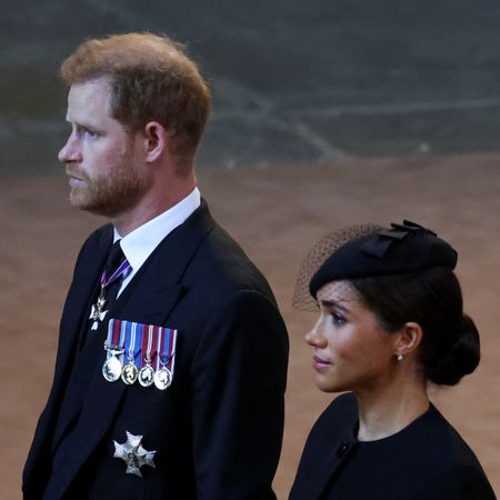 Prince Harry and Meghan, Duchess of Sussex walk as procession with the coffin of Britain's Queen Elizabeth arrives at Westminster Hall from Buckingham Palace for her lying in state on September 14, 2022 in London, United Kingdom. Queen Elizabeth II's coffin is taken in procession on a Gun Carriage of The King's Troop Royal Horse Artillery from Buckingham Palace to Westminster Hall where she will lay in state until the early morning of her funeral. Queen Elizabeth II died at Balmoral Castle in Scotland on September 8, 2022, and is succeeded by her eldest son, King Charles III.