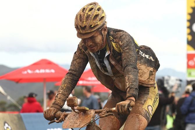 A muddy Robert Mennen of Topeak-Ergon Racing after winning stage 2