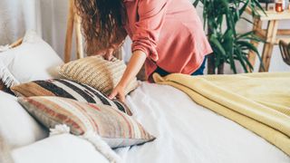 A woman making the bed