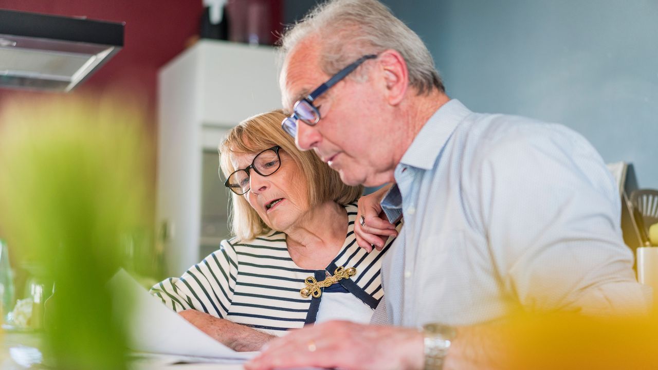 picture of elderly couple working on tax return