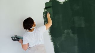 A woman painting the walls