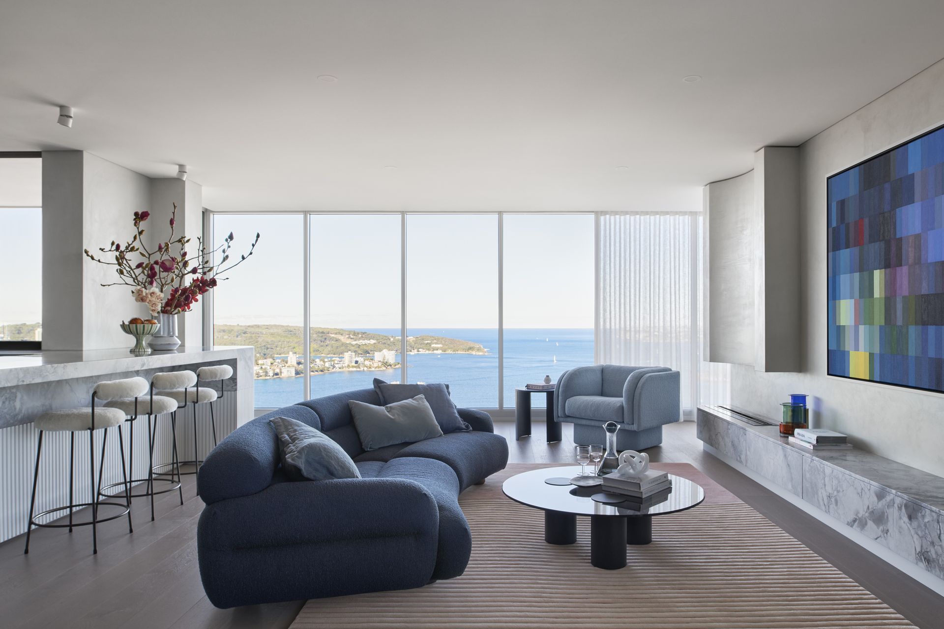 A living room with blue boucle furniture