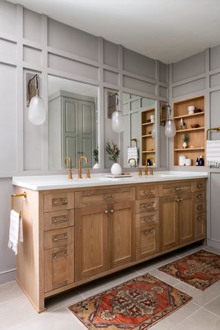 Grey bathroom with wooden vanity and built in mirrors