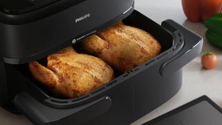 Philips 1000 Series Dual Basket Airfryer with two small chickens inside