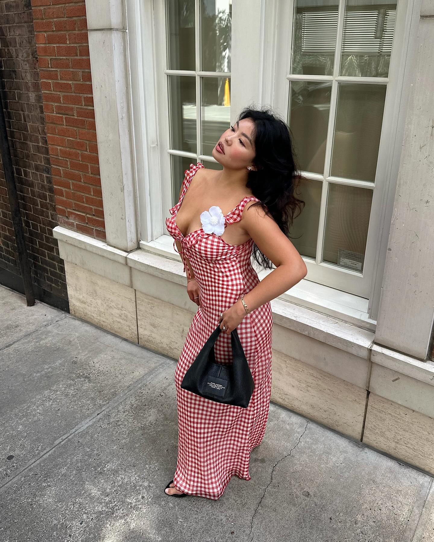 Allison Ho wearing a red gingham dress with a flower pin
