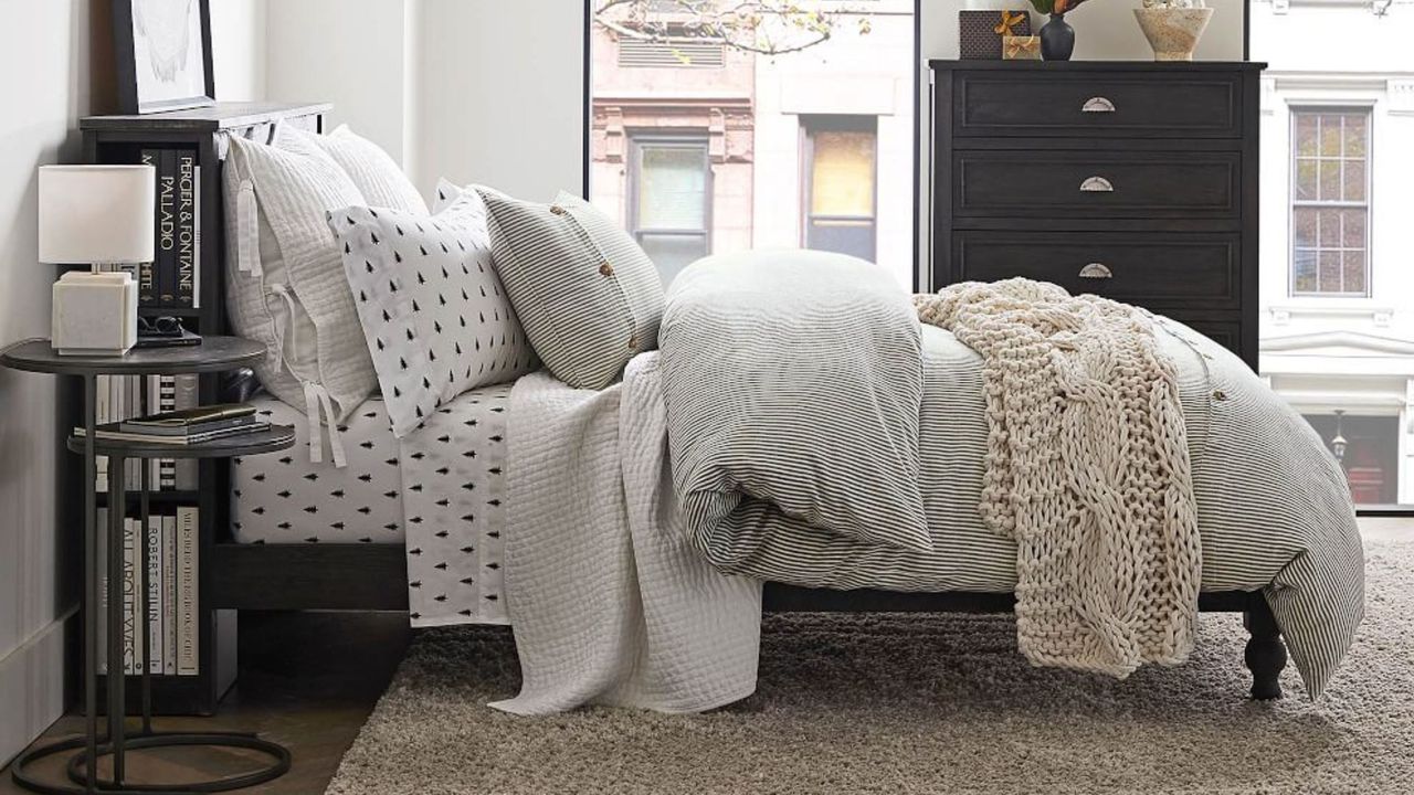 Christmas bedding sets pine trees on bed with windows behind and lots of cushions on top