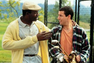 Chubbs Peterson (Carl Weathers) extends a hand to Happy Gilmore (Adam Sandler) on the golf course in Happy Gilmore