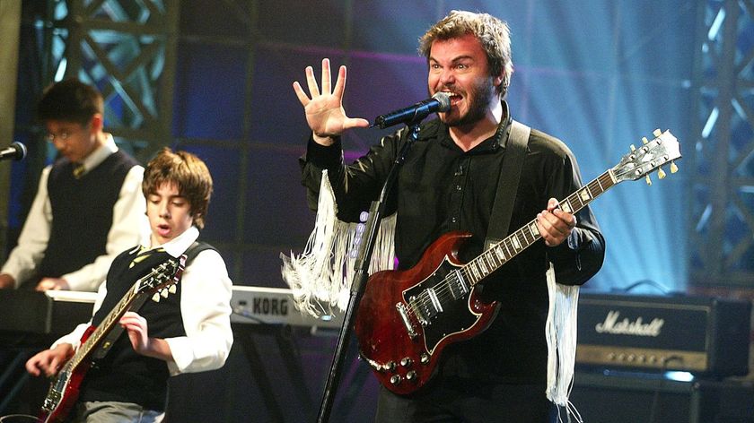 "School of Rock" cast members Jack Black (R), Robert Tsai (L) and Joey Gaydos Jr. appear on "The Tonight Show with Jay Leno" at the NBC Studios on September 26, 2003 in Burbank, California