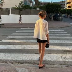 Influencer wears wedge mules.