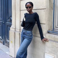 Woman wearing a black top and jeans