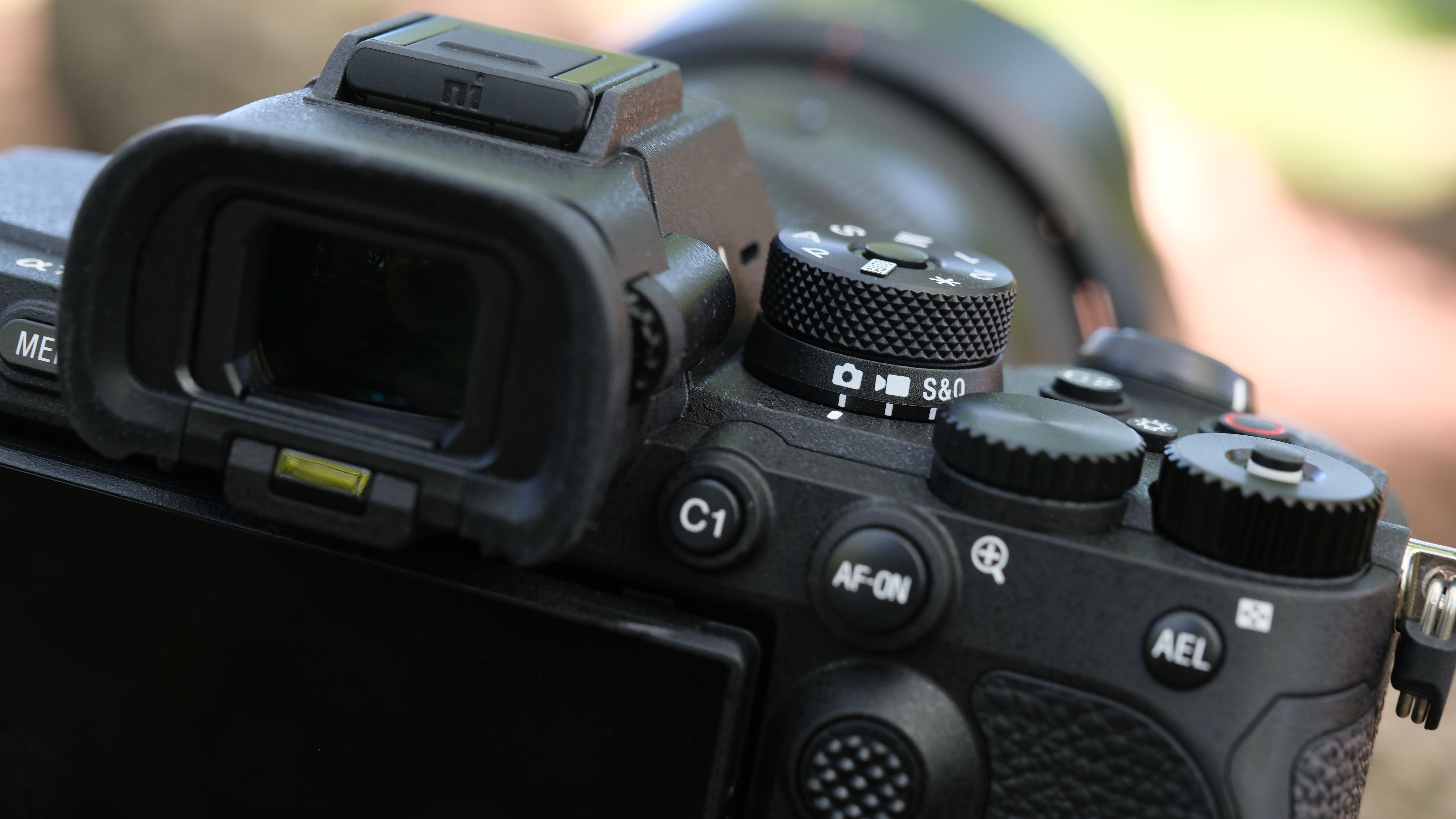 Close-up of the Sony A7R VI top controls, viewfinder and mode dial.