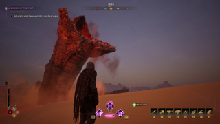 A sandworm rises out of the desert sand, dwarfing the player.