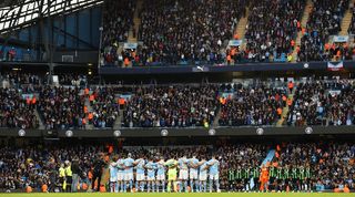 Manchester City and Brighton fans observe a minute's silence in memory of victims of the recent attacks in Israel and Gaza in October 2023.