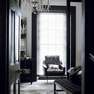 Bedroom with chandelier with black walls