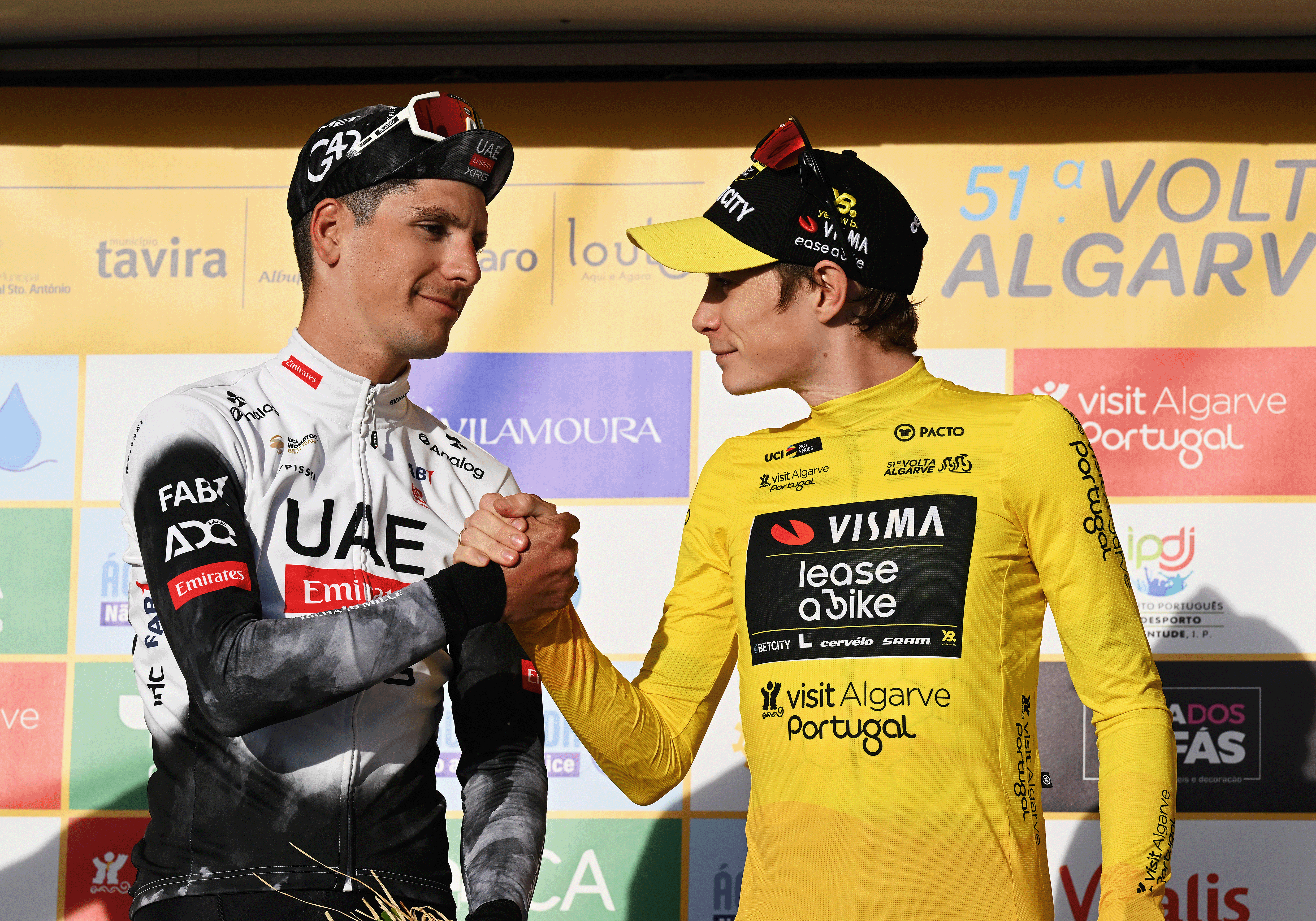 MALHAO, PORTUGAL - FEBRUARY 23: (L-R) Joao Almeida of Portugal and UAE Team Emirates - XRG on second place and race winner Jonas Vingegaard of Denmark and Team Visma | Lease a Bike - Yellow leader jersey on the podium ceremony after the 51st Volta ao Algarve em Bicicleta, Stage 5 a 19.6 individual time trial stage from Salir to Malhao 477m on February 23, 2025 in Malhao, Portugal. (Photo by Tim de Waele/Getty Images)