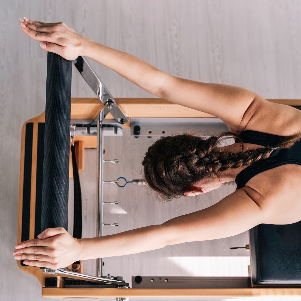 Best at-home Reformer Pilates machines - woman using reformer