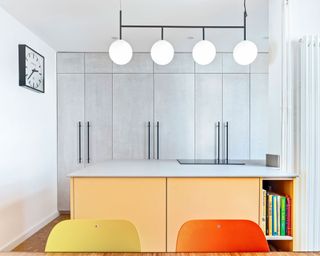 modern kitchen with yellow island and grey cupboards