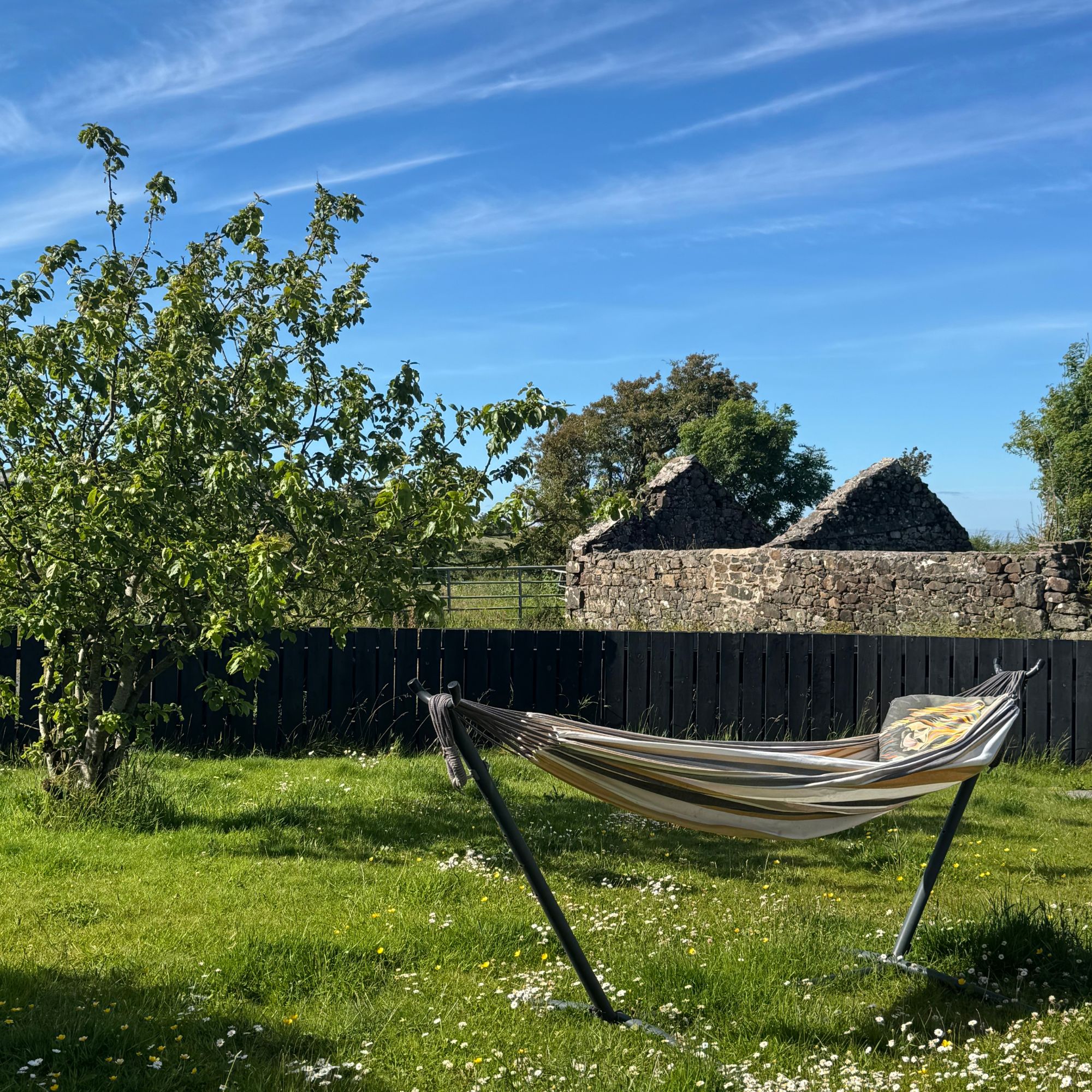 A real-life shot of writer Heidi Scrimgeour's hammock from Amazon Basics pictured in her garden on a sunny day