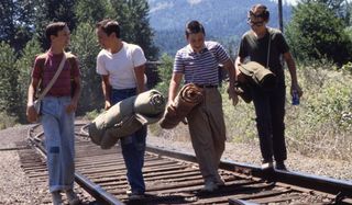 Wil Wheaton, River Phoenix, Jerry O'Connell, and Corey Feldman walk on the train tracks in Stand By Me.
